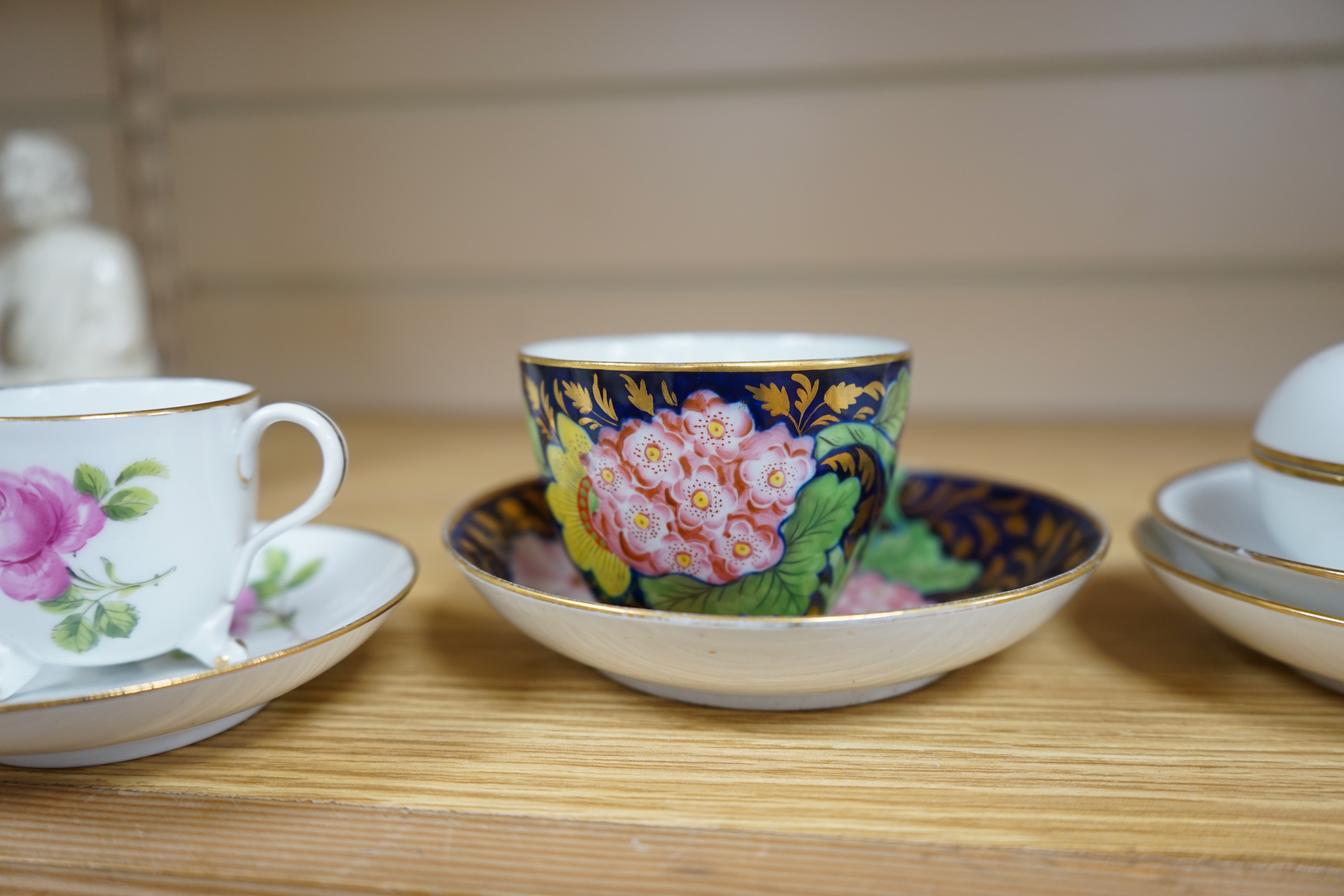 A collection of outside decorated Meissen and porcelain to include a pair of cups and saucers and a box and cover (6). Condition - fair to good